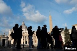 People queue to enter St. Peter's Basilica, at the Vatican, Dec. 29, 2022.