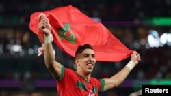 Morocco's Jawad El Yamiq celebrates after qualifying for the quarterfinals of the 2022 FIFA World Cup after the Atlas Lions defeated Spain in Al Rayyan, Qatar, Dec. 6, 2022.