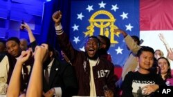 Supporters cheer during an election night watch party for Democratic Sen. Raphael Warnock, Dec. 6, 2022, in Atlanta. Sen. Warnock has defeated Republican challenger Herschel Walker in a runoff election in Georgia.