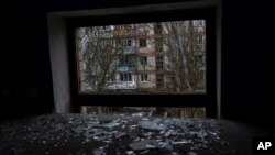 Broken glass lies on the floor of a building damaged during a Russian strike in Kherson, southern Ukraine, Nov. 25, 2022. 