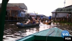 Residents of Ganvie in the commune of Sô-Ava, on the outskirt of Benin's capital, Cotonou seen on their boats in a video footage by VOA.
