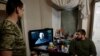 Ukrainian soldiers watch Ukraine's President Volodymyr Zelenskiy’s New Years Eve address to the nation, in a military rest house, as Russia's attack on Ukraine continues, in region of Donetsk, Dec. 31, 2022. 