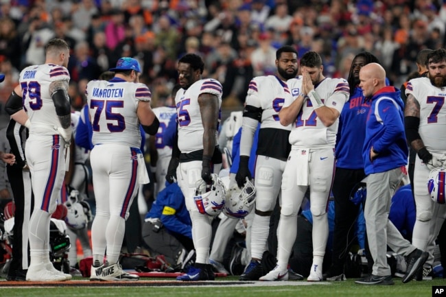 Buffalo Bills quarterback Josh Allen (17) pauses as Damar Hamlin is examined during the first half of an NFL football game against the Cincinnati Bengals, Monday, Jan. 2, 2023, in Cincinnati. (AP Photo/Jeff Dean)