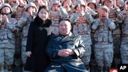 This undated photo provided on Nov. 27, 2022, by the North Korean government shows North Korean leader Kim Jong Un and his daughter with soldiers at an unidentified location in North Korea. 