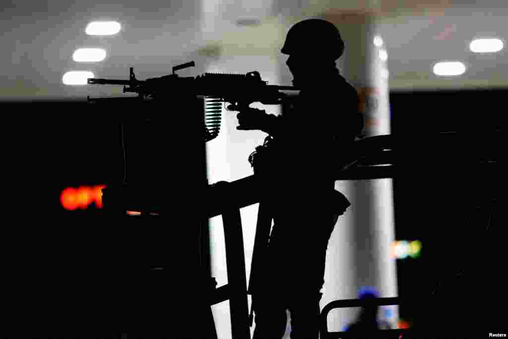 A member of the Mexican Army stands guard at the scene where unknown assailants attacked police officers from the State Investigation Agency (AEI) in Ciudad Juarez, Mexico, Jan. 2, 2023.