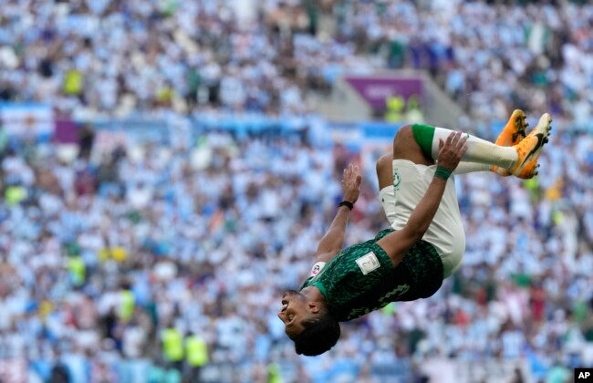 Saudi Arabia's Salem Al-Dawsari celebrates after scoring his side's second goal during the World Cup group C soccer match between Argentina and Saudi Arabia at the Lusail Stadium in Lusail, Qatar, Nov. 22, 2022.