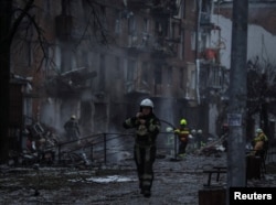 Rescuers work at a site of a residential building destroyed by a Russian missile attack, as Russia's attack on Ukraine continues, in the town of Vyshhorod, near Kyiv, Ukraine, Nov. 23, 2022.