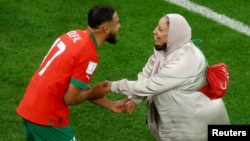 Morocco's Sofiane Boufal celebrates with his mother after his team beat Portugal in the World Cup in Doha, Qatar, on Dec. 10.