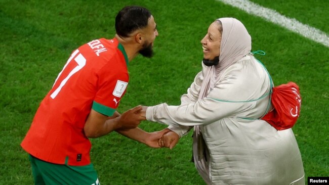 Morocco's Sofiane Boufal celebrates with his mother after his team beat Portugal in the World Cup in Doha, Qatar, on Dec. 10.