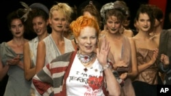 FILE - Models applaud as British fashion designer Vivienne Westwood salutes the public after the presentation of her Spring/Summer 2006 collection in Paris, Oct. 4, 2005.