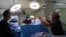 Perawat membantu ahli bedah ginekologi Dr. Marci Bowers saat dia melakukan operasi pemulihan klitoris pada seorang wanita yang sebelumnya pernah disunat (FGM), di sebuah klinik di Nairobi, Kenya, 17 November 2022. REUTERS/Monicah Mwangi