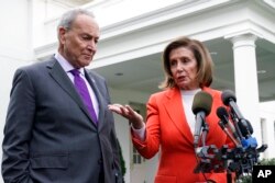 FILE - Senate Majority Leader Chuck Schumer of N.Y., right, listens as House Speaker Nancy Pelosi of California speaks to reporters at the White House in Washington, Nov. 29, 2022.