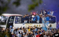 Players of the Argentine soccer team that won the World Cup in Qatar are greeted in Buenos Aires, Argentina, Dec. 20, 2022.