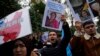 Protesters chant slogans as they hold posters and pictures of victims during a protest against China's brutal crackdown on Uyghurs, in front of the Chinese consulate in Istanbul, Turkey, Nov. 30, 2022. 