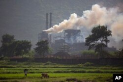 FILE- Smoke rises from a coal-powered steel plant at Hehal village near Ranchi, India, in eastern state of Jharkhand, Sept. 26, 2021. (AP Photo/Altaf Qadri)