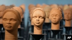 Sculptures created by French artist Prune Nourry representing the approximately100 Chibok schoolgirls still in captivity are displayed in Lagos, Nigeria, Dec. 13, 2022. 