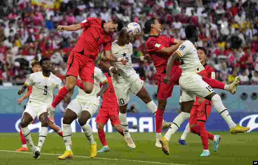 South Korea&#39;s Kim Min-jae, left, and Ghana&#39;s Andre Ayew, right, jump to head the ball during the World Cup group H soccer match between South Korea and Ghana, at the Education City Stadium in Al Rayyan, Qatar.