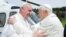 FILE - Pope Francis (L) embraces Pope Emeritus Benedict XVI as he arrives at the Castel Gandolfo summer residence, Italy, March 23, 2013. 