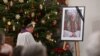 A photograph of late former Pope Emeritus Benedict XVI is seen during a Rosary prayer in the Catholic St Oswald church in his birth town Marktl am Inn, southern Germany, on Jan. 1, 2023, the day after his death. 