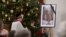 A photograph of late former Pope Emeritus Benedict XVI is seen during a Rosary prayer in the Catholic St Oswald church in his birth town Marktl am Inn, southern Germany, on Jan. 1, 2023, the day after his death. 