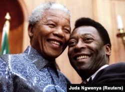 President Nelson Mandela and Brazilian soccer legend Pele smile for photographers at Union Buildings in Pretoria, South Africa, March 1995.