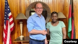 Martha Chizuma poses with Ambassador David Young hours after her arrest, Dec. 6, 2022. (Photo courtesy of the American Embassy in Malawi)