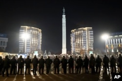FILE - Riot police block protesters as they gather in the center of Almaty, Kazakhstan, Jan. 5, 2022. Demonstrators denounced the doubling of prices for liquefied gas in protests throughout the country.