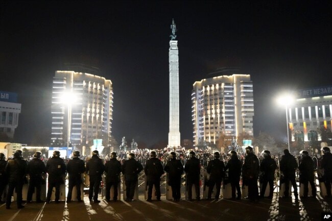 FILE - Riot police block protesters as they gather in the center of Almaty, Kazakhstan, Jan. 5, 2022. Demonstrators denounced the doubling of prices for liquefied gas in protests throughout the country.