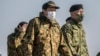 Japan's Defense Minister Hamada Yasukazu (C) inspects a joint military drill among Japan, the US, Britain and Australia at Narashino exercise field in Funabashi of Chiba prefecture on Jan. 8, 2023. 