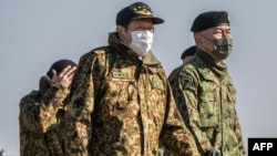 Japan's Defense Minister Hamada Yasukazu (C) inspects a joint military drill among Japan, the US, Britain and Australia at Narashino exercise field in Funabashi of Chiba prefecture on Jan. 8, 2023. 