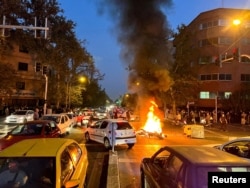 FILE - A police motorcycle was burned during protests over the death of Mahsa Amini, an Iranian woman who died after being arrested by the Islamic Republic "moral police," Held on September 19, 2022 in Tehran, Iran.  (West Asia News Agency, Reuters)