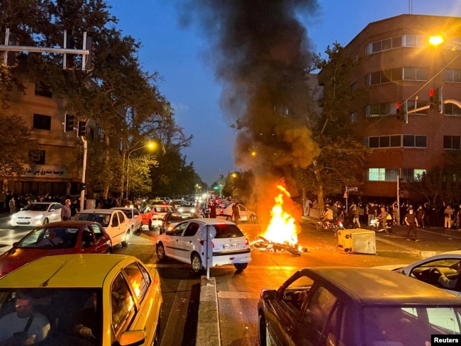FILE - A police motorcycle burns during a protest over the death of Mahsa Amini, an Iranian woman who died after being arrested by the Islamic republic's "morality police," in Tehran, Iran, on Sept. 19, 2022. (West Asia News Agency via Reuters)