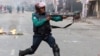 A policeman fires his gun at opposition BNP activists in Dhaka, Bangladesh, Dec 7, 2022. One BNP activist was killed and over 60 activists were injured as a result of police using force. 