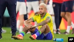 Brazil's Neymar sits on the pitch at the end of the World Cup quarterfinal soccer match against Croatia in Al Rayyan, Qatar, Dec. 9, 2022.