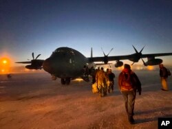 Helpers in the Alaska National Guard's Operation Santa Claus board a cargo plane at Joint Base Elmendorf-Anchorage for a flight to Nuiqsut, Alaska, Nov. 29, 2022.