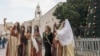 Women visit the Church of the Nativity, believed to be the birthplace of Jesus Christ, in the West Bank town of Bethlehem, Dec. 24, 2022.