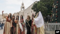 Women visit the Church of the Nativity, believed to be the birthplace of Jesus Christ, in the West Bank town of Bethlehem, Dec. 24, 2022.