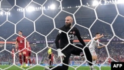 Switzerland's Remo Freuler, right, celebrates scoring his team's third goal past Serbia's goalkeeper Vanja Milinkovic-Savic during a World Cup match at Stadium 974 in Doha on Dec. 2, 2022.