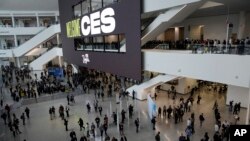 FILE: People enter the Las Vegas Convention Center before the start of the CES tech show on Thursday, Jan. 5, 2023,
