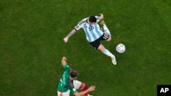 Argentina's Lionel Messi scores his side's opening goal during the World Cup group C soccer match between Argentina and Mexico, at the Lusail Stadium in Lusail, Qatar, Nov. 26, 2022. 