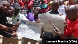 Support staff of the Malawi judiciary carry placards in Blantyre as part of a nationwide strike, Dec. 13, 2022.