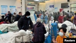 Patients lie on beds in a waiting area in the emergency department of Zhongshan Hospital, amid the COVID-19 outbreak in Shanghai, Jan. 3, 2023.