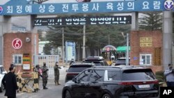 A convoy of vehicles, one of them carrying K-pop band BTS's member Jin arrive at an army training center in Yeoncheon, South Korea, Dec. 13, 2022. 