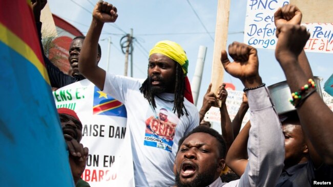 Congolese residents chant as they protest the deployment of a regional force which they see as ineffective in tackling the resurgent rebel group in North Kivu following renewed tensions around Goma in the North Kivu province of the Democratic Republic of Congo.