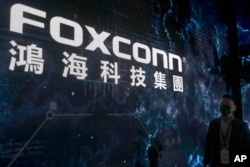 FILE - The Foxconn logo is seen during the Hon Hai Tech Day at the Nangang Exhibition Center in Taipei, Taiwan, on Oct. 18, 2022.