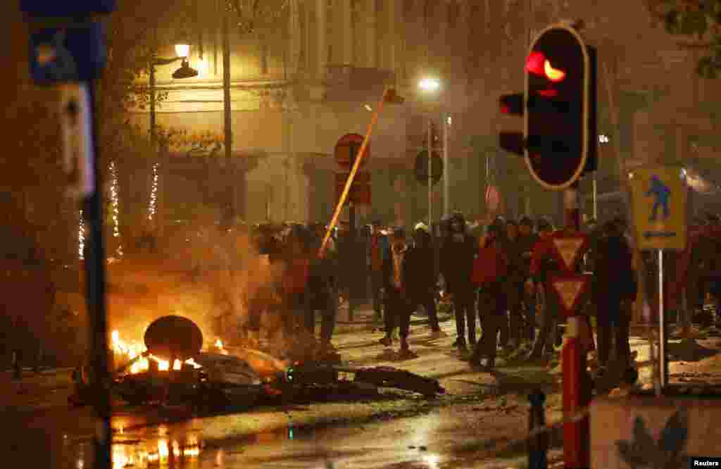 People clash with the police in Brussels, Belgium after the World Cup group F soccer match between Belgium and Morocco, at the Al Thumama Stadium in Doha, Qatar.