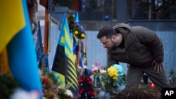 Ukrainian President Volodymyr Zelenskyy, pays tribute at a monument to Fallen Defenders of Ukraine in the Russian-Ukrainian War in Lviv, Ukraine, Jan. 11, 2023.