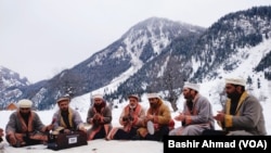 Men singing on snow slopes in Dawar, Gurez valley of Bandipora district of Jammu and Kashmir.