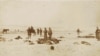 This photograph by Chadron, Nebraska, photographer George E. "Gus" Trager photographer shows soldiers holding moccasins and other items they have looted from the dead at the Wounded Knee Massacre site.