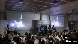 Officials of ispace Inc's HAKUTO-R mission look at live broadcasting of the launch of a SpaceX Falcon 9 rocket for ispace at Cape Canaveral Space Force Station, in Tokyo, Dec. 11, 2022. (Kyodo via Reuters)